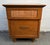 A charming mid-century modern walnut nightstand featuring a distinctive cane-faced drawer that adds texture and visual...