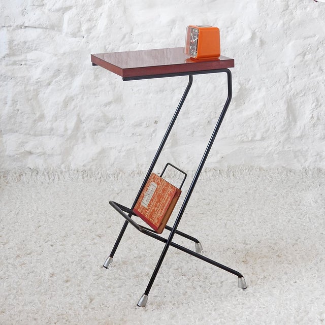 Essentially, this is a stand that was once used to hold a landline telephone and phone book—a relic of another era. Now it...