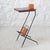 Essentially, this is a stand that was once used to hold a landline telephone and phone book—a relic of another era. Now it...
