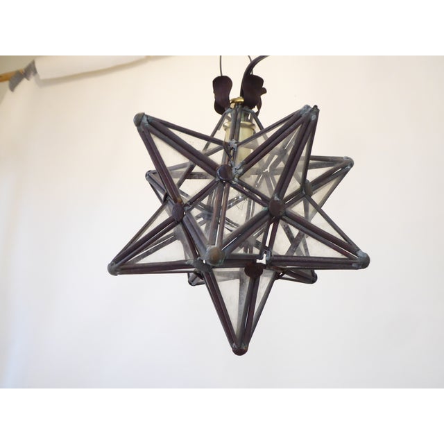 This copper star light, opens to change the bulb and uses one candelabra bulb up to 60Watts.