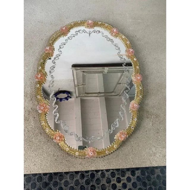 Important mirror with Murano glass style transparent elements and pink flowers full of gold leaf. Oval mirror with...