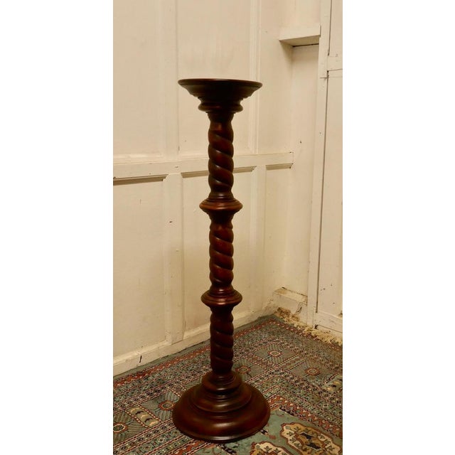 19th century carved mahogany pedestal torchere. The column has a barley twist turning, both top and bottom are round, the...