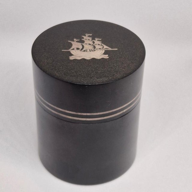A rare decorative (cigarette) box in isolite (early plastic material) and decor of ship in silver inlay. Made by...