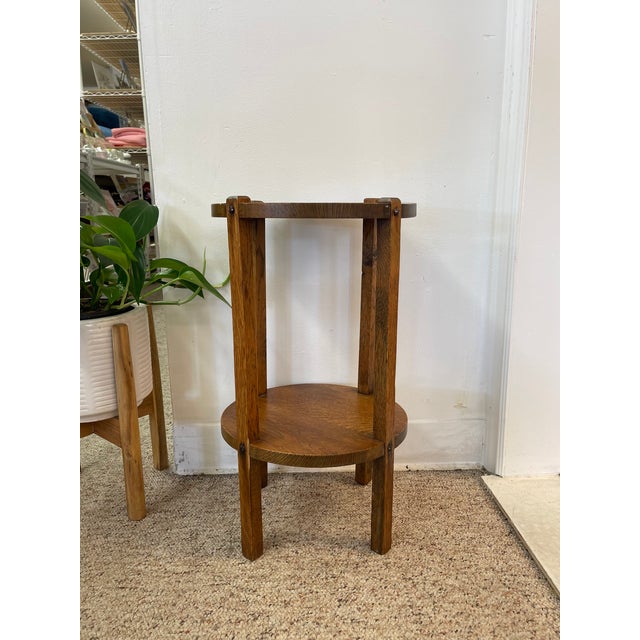 This likely early 20th-century Mission-style plant stand or side table is a fine example of American Arts and Crafts...
