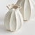 With a sculpted body and thicklyapplied reactive glaze, this pair of bud vases is a work of art. The handfinished details...
