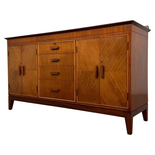 A handsome and beautifully proportioned vintage 20th-century sideboard, finely crafted from teak and distinguished by its...