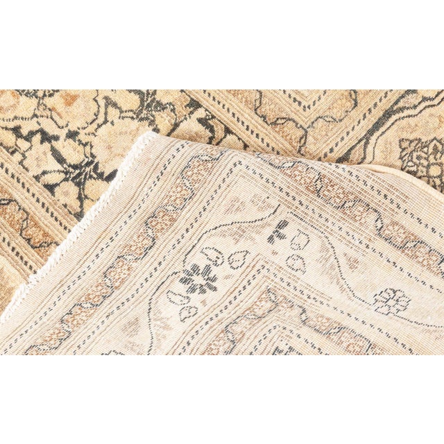 A late 19th century Persian Tabriz botanic size adjusted carpet having the beige filed with four panels of twelve...