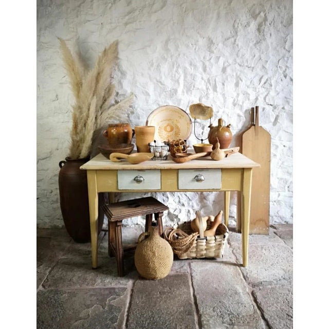 Antique rustic 19th-century table. Made of solid pine with two drawers and a painted base, very stable and durable, with a...