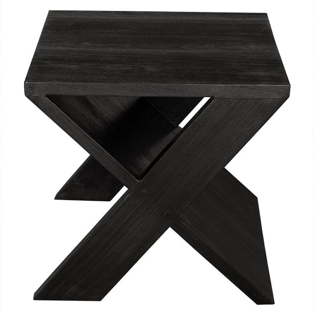 This sculptural side table in Burnt Black showcases a striking X-shaped base. Its minimalistic design merges functionality...