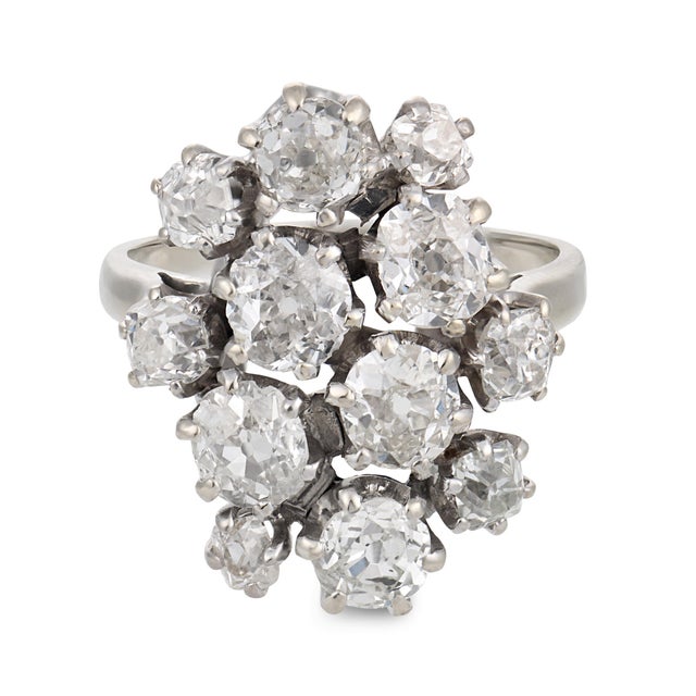 This striking French Mid Century cocktail ring showcases an impressive cluster of 12 old mine cut diamonds totaling...