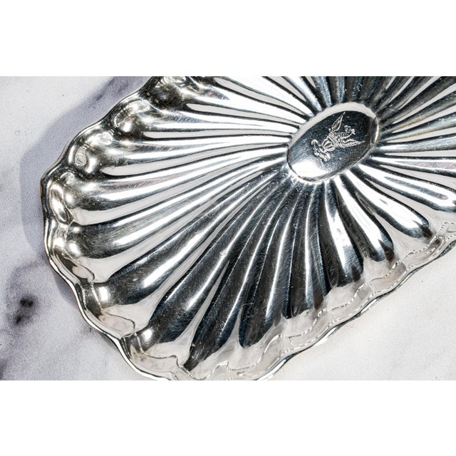 An exquisite example of Victorian elegance and refined silversmithing, this antique sterling silver card tray by the...