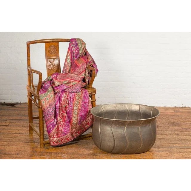 A vintage Indian silver over brass planter from the Mid-20th Century, with oval shape and wave design. Created in India...