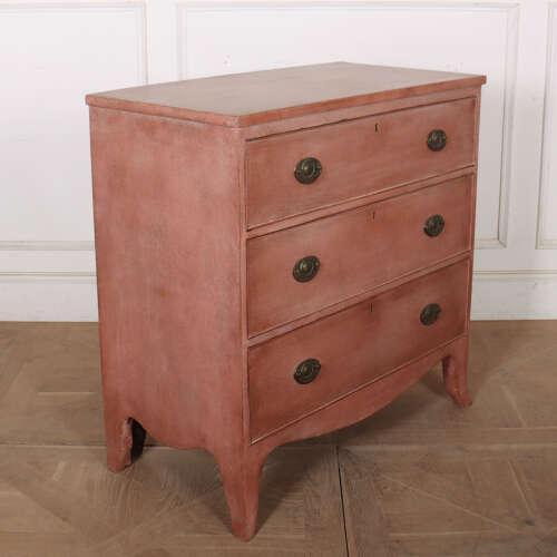 Early 19th Century English painted three drawer chest of drawers with later paint. 1820. This piece is designed in the...