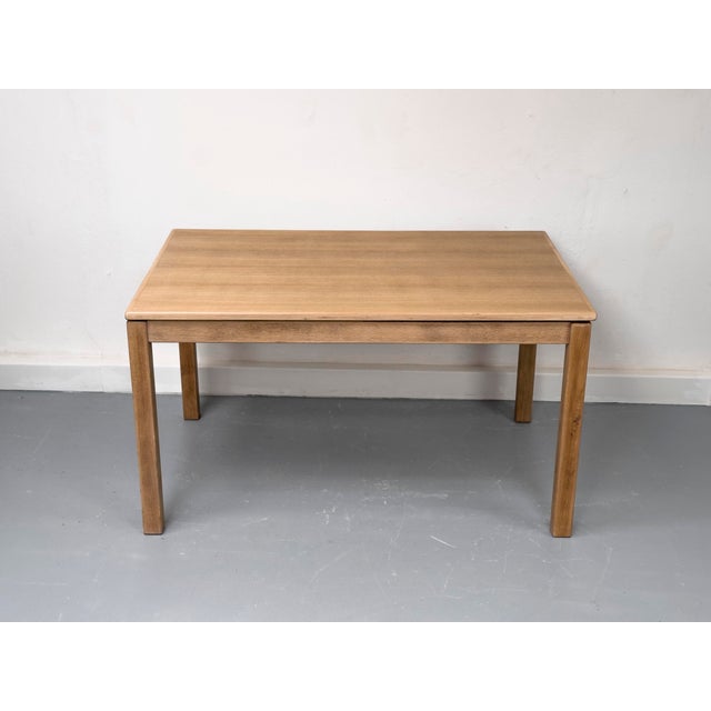 A very high-quality, rectangular oak dining table in a minimalist, straight-lined style typical of the 1970s. The table...