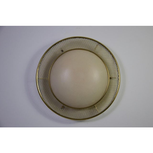 This elegant midcentury flush mount ceiling light by erco, crafted in the 1960s, is a refined example of german modernist...