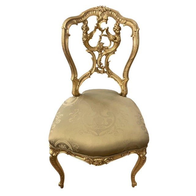 A refined 19th century French hand-carved gilded chair, beautifully executed in the Rococo Revival taste and distinguished...