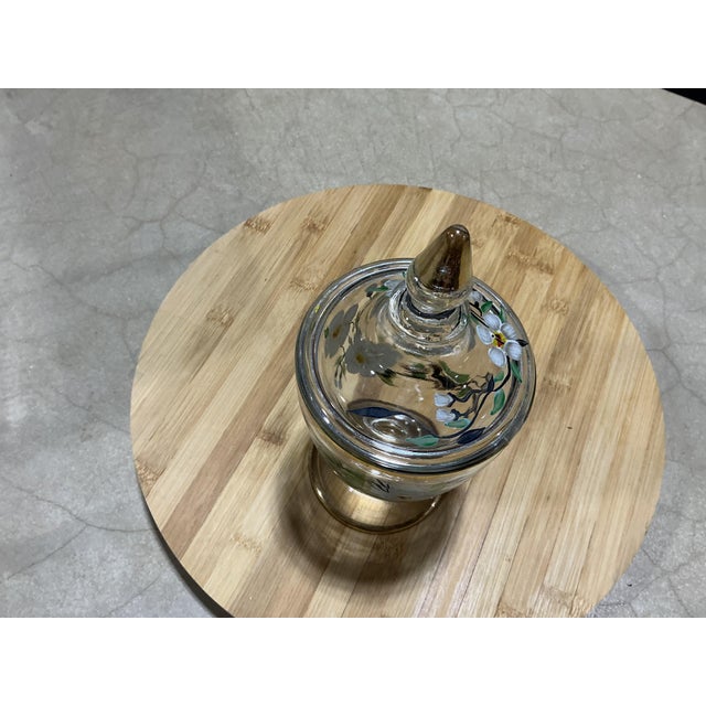 Add a touch of vintage charm to your tabletop or vanity with this exquisite mid-century footed glass urn/candy jar....