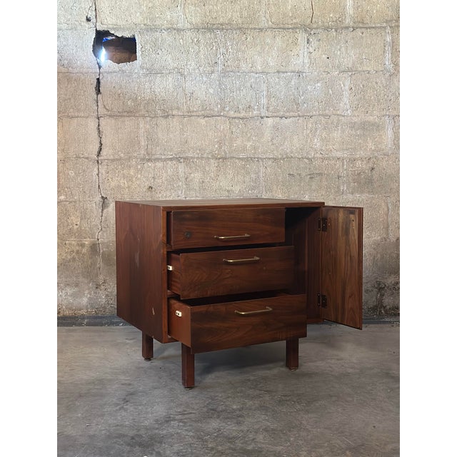 Such a sweet storage piece! A petite little cabinet in walnut by Jens Risom. Mid century period with original brass bar...