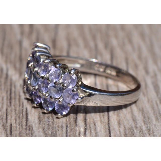 The Pointe Drive Tanzanite Three Row Band. The band is set with lavender colored tanzanite in three rows of round...