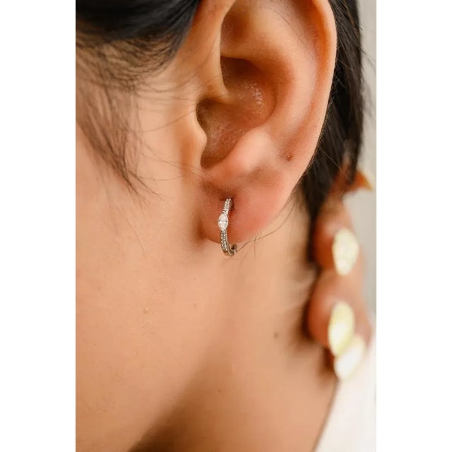 This is part of Chairish’s Fine Jewelry assortment. Tiny Diamond Huggie Hoops Earrings For Her in 18K Gold to make a...