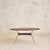 A 1950s Italian oval coffee table, defined by its richly veined onyx top and sculptural brass base. The oval top is carved...