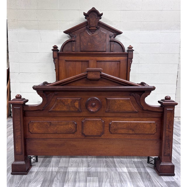 This is a gorgeous antique Monumental Victorian full sized walnut and burl wood bed, circa 1880s, featuring striking...