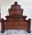 This is a gorgeous antique Monumental Victorian full sized walnut and burl wood bed, circa 1880s, featuring striking...