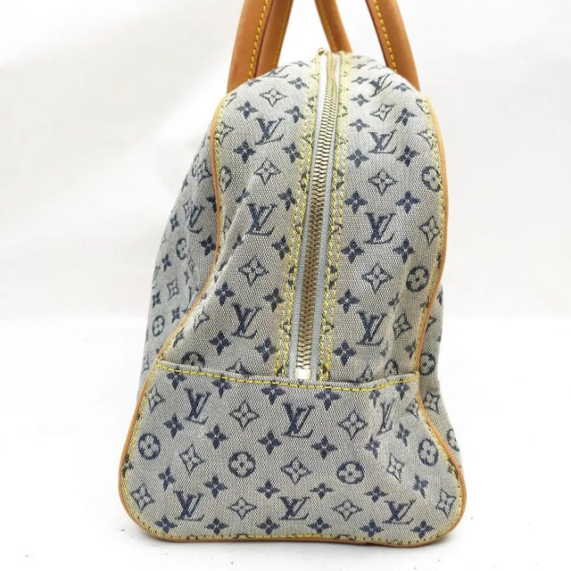 This elegant Louis Vuitton Marie handbag is crafted from navy blue and beige Monogram Mini jacquard canvas, offering a...