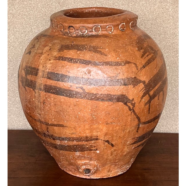 This is a terracotta olive jar from central Spain. It has a wonderful aged patina with chalky painted finish. It makes a...