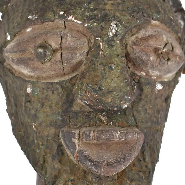 This figure has a strongly defined body and the well-known Songye jutting chin and geometric nose, with the eyes...