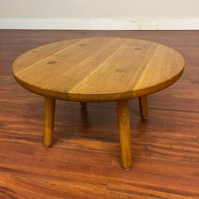 Vintage solid oak round occasional table useable as a side or a coffee table. It features seamless, gently rounded edges...