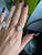 A 5.6-carat ethiopian opal cabochon sits at the centre of this solid 14K yellow gold ring, framed by fifty-six earth-mined...