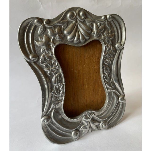Spanish Colonial style pewter curved picture frame with wood back. Top center of frame is designed with a graceful conch...