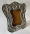 Spanish Colonial style pewter curved picture frame with wood back. Top center of frame is designed with a graceful conch...