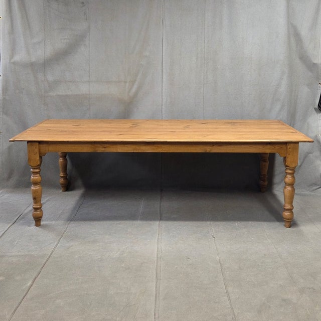 A beautiful, classic 8' long vintage English rustic pine farmhouse harvest dining table with gorgeous turned legs. The...
