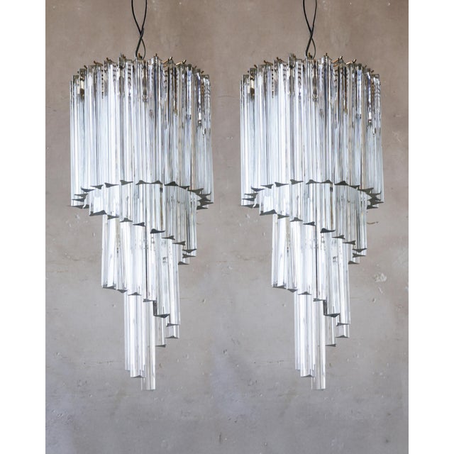 A pair of Venetian pendant lamps with ‘Triedri’ prisms made of Murano glass, attributed to Venini, circa 1970. The prisms...