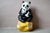 A giant panda and its cub nestled together, this large animal cast is a donation box for the World Wildlife Foundation....