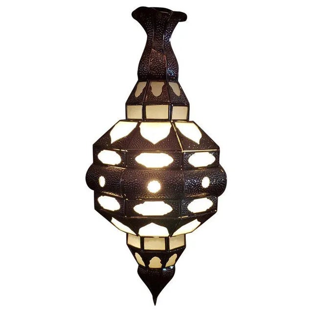 Handmade Moroccan glass lantern with frosty white stain glass and metal rustic frame, measuring around 24" in height and...