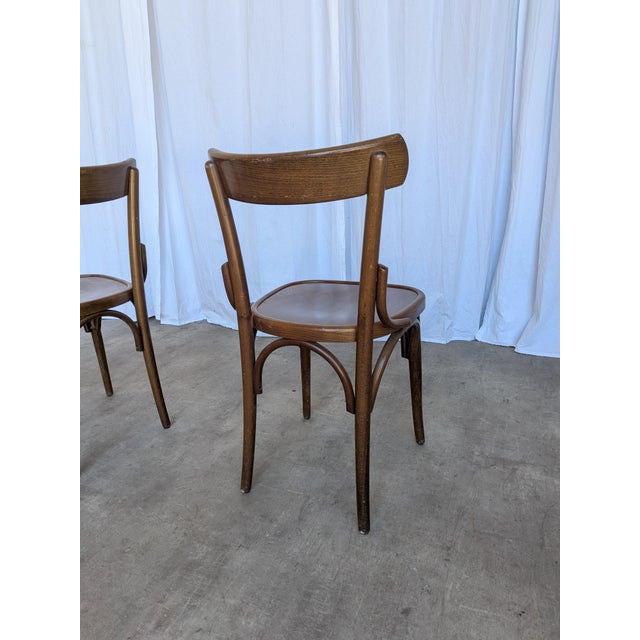 Vintage wooden dining chairs were made in Former Yugoslavia during the 1970s. Crafted entirely from solid wood, they...