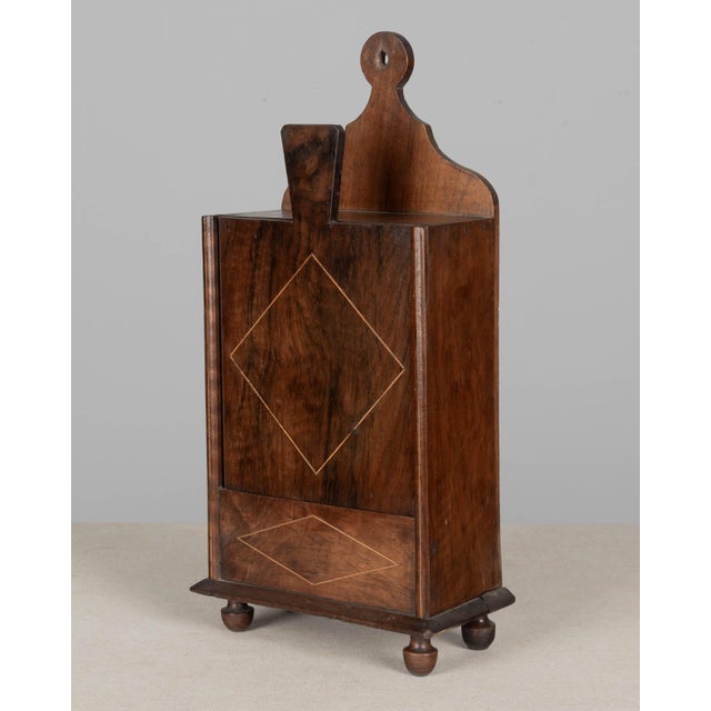A 19th century French fariniere, made of walnut with marquetry inlaid detail and turned feet. Good craftsmanship. Back...