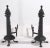 Impressive pair of large Arts and Crafts andirons, of hand wrought iron with brass studs. The and irons are in a late...