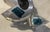A whimsical aluminum sculpture titled "Piece of Cake," by Pennsylvania sculptor Herbert Simon, dated 1992. Two elements: a...