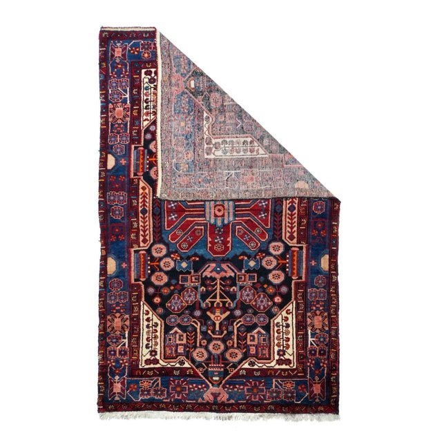 The near black field violates the inner minor border on all four sides. A large red and medium blue medallion dominates...