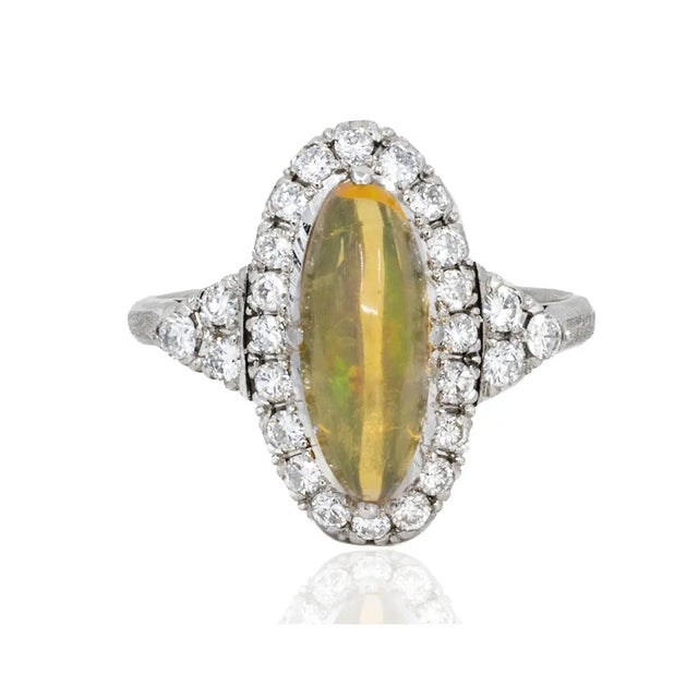 Platinum Ring with approximate 2.50 carat fire opal and 26 diamonds weighing approximatley 0.70 carats. 6.11 grams