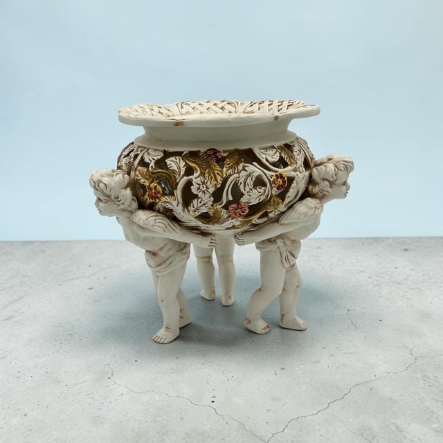 This vintage Ardalt / Luigi Antorini Italian porcelain centerpiece bowl features an ornate openwork vessel supported by...