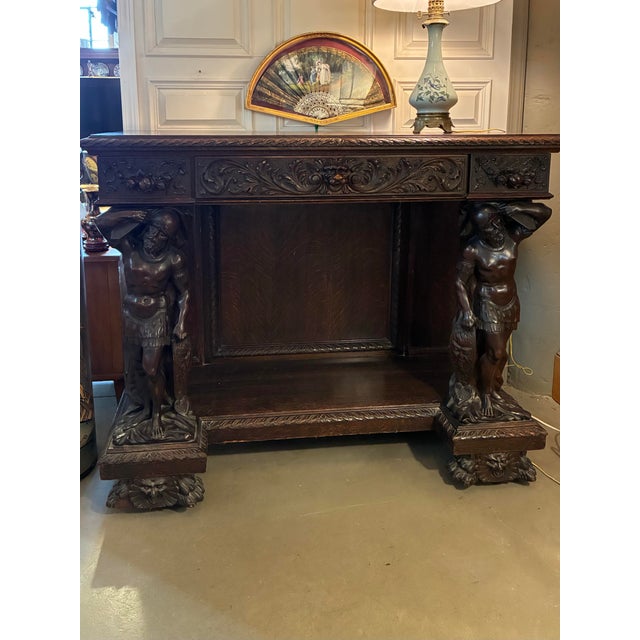 Carved tiger oak sideboard or huntboard supported by Renaissance style carved figures, fruit panels, animal heads and...