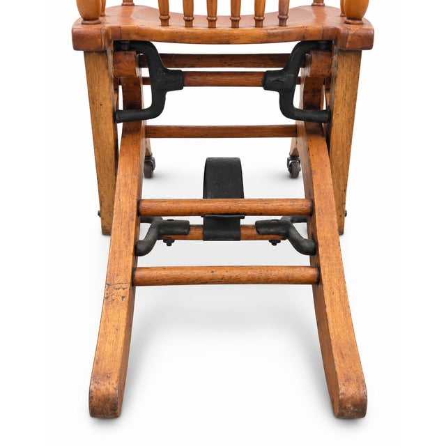 Antique-style wooden child’s convertible high chair with a beautifully shaped backrest, turned spindles, curved armrests,...