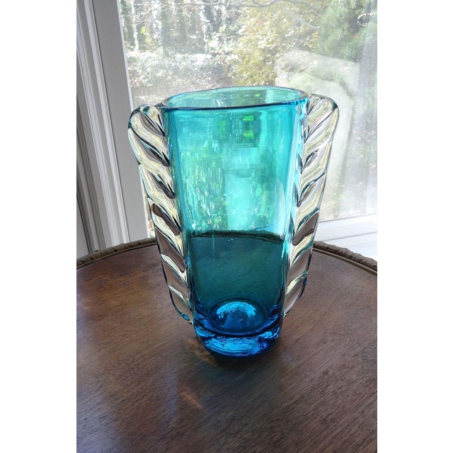 A rarer Blenko, non-crackle, hand-blown vase. This vase has a turquoise tapering body with hand-applied clear glass wings....