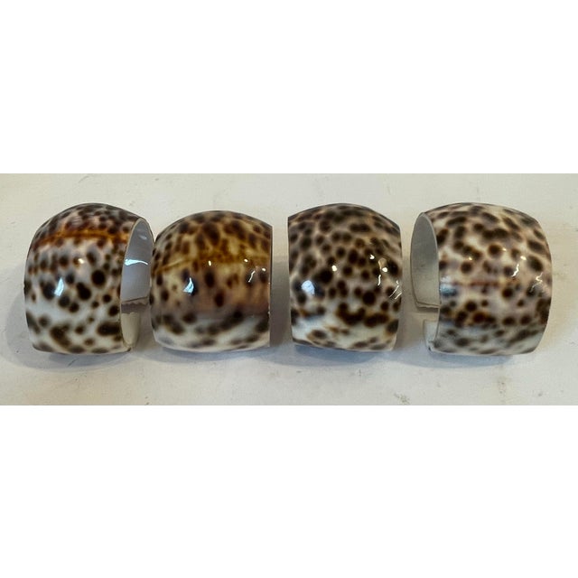 Nice heavy set of four cowrie shell napkin rings!