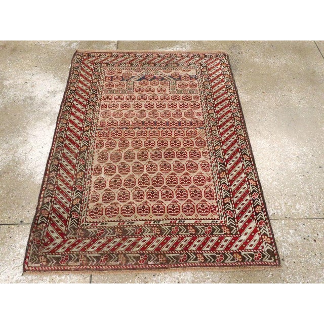 An antique Caucasian Shirvan rug. The rows of botehs reverse direction on the beige field of this east Caucasian prayer...